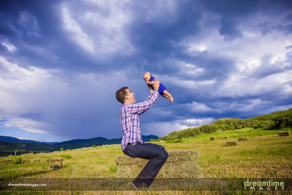 A father plays with his son in the air near Aspen